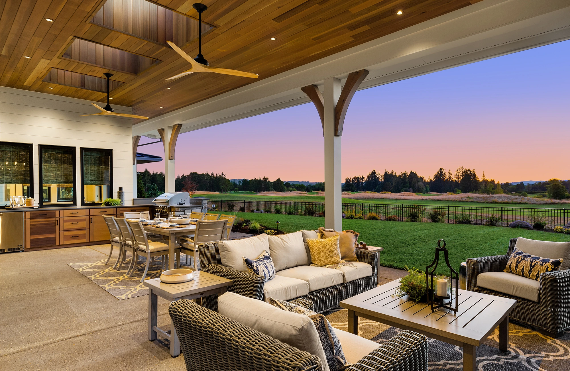 Luxury covered outdoor living space featuring a custom wood ceiling, outdoor kitchen, and spacious patio by Window Design and Remodeling.